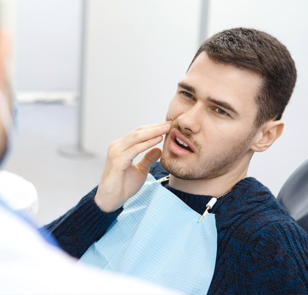 Patient receiving dental examination or treatment in modern dental office setting.
