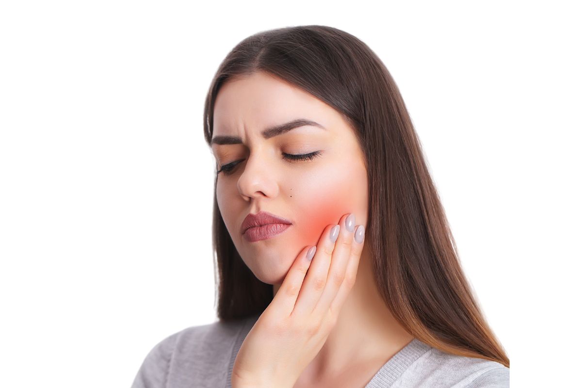 Woman experiencing jaw pain, touching her cheek with red highlight indicating discomfort area.