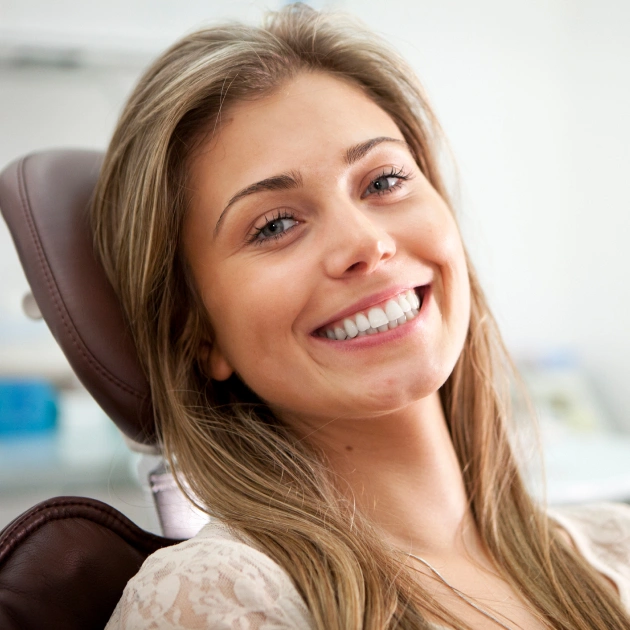 Smiling woman in dental chair at Diamond Lakes Dental office during appointment.